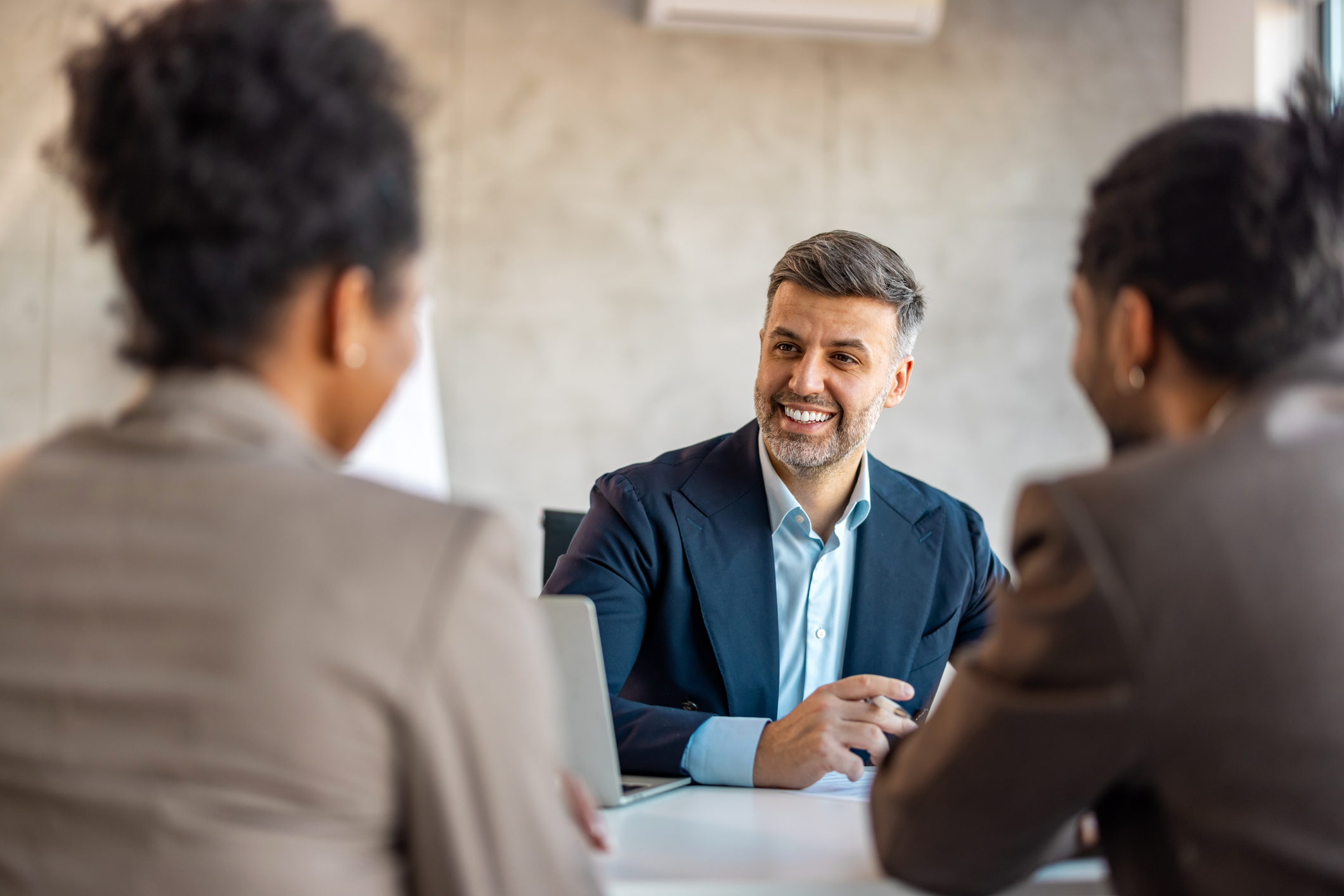 an new owner meeting with a businesses management team
